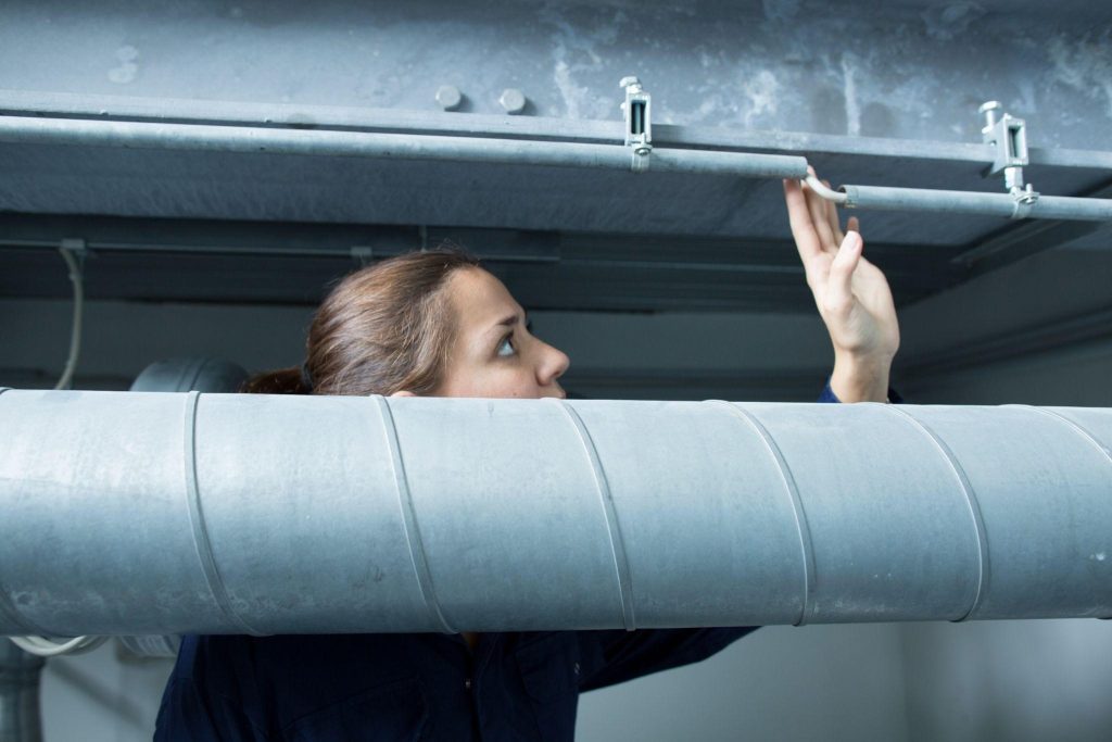 HVAC expert in Newark, New Jersey inspecting air ducts for mold. Professional tips for preventing mold growth in your ventilation system.