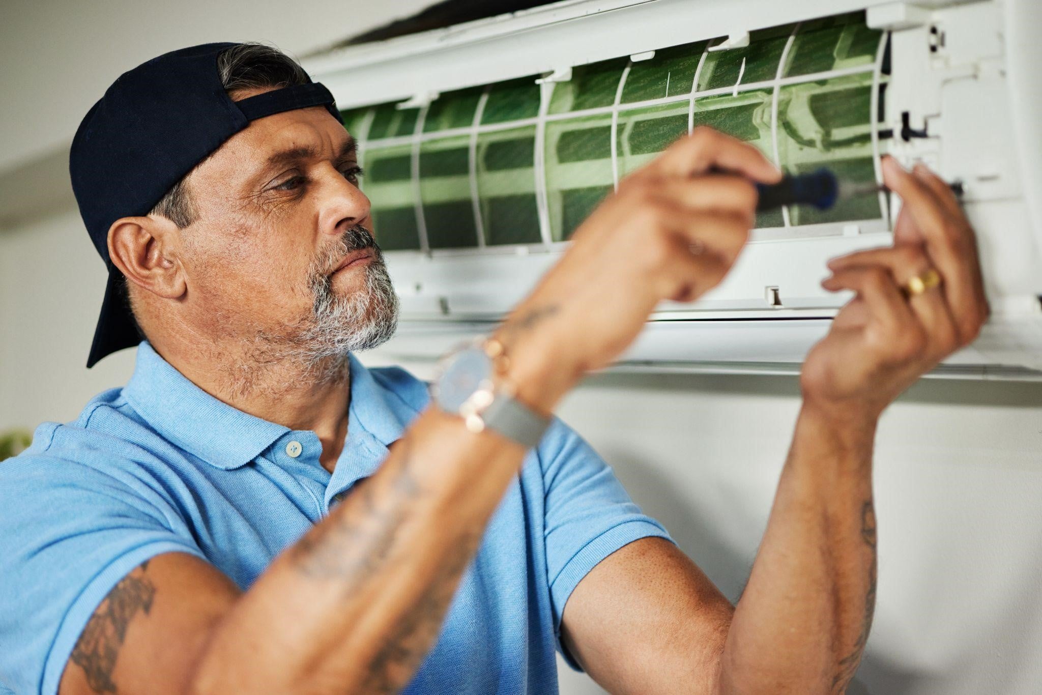 a technician fixing a non working air conditioner