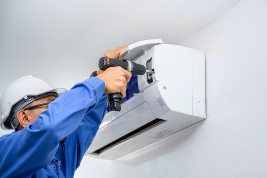 a local contractor fixing an ac unit