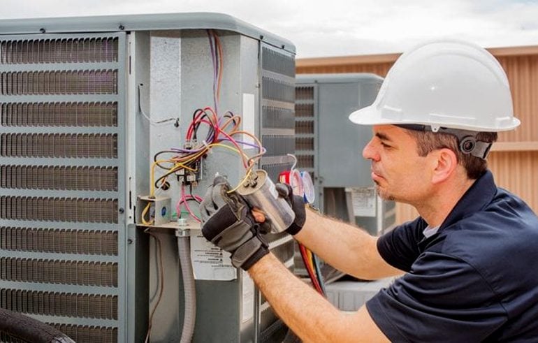 a technician fixing a non workable ac