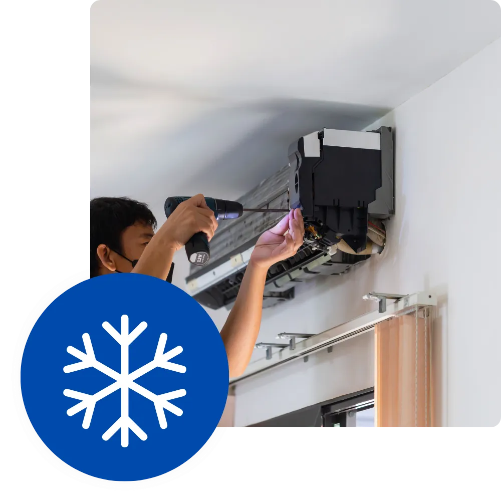 HVAC technician repairing an air conditioner with a power drill. AC maintenance in Newark, New Jersey for optimal home climate control.